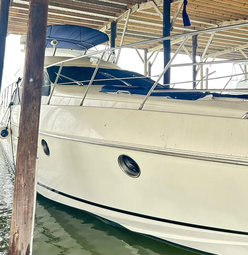 Slide: The Image of 2006 Azimut 62 yacht docked under a wooden shelter. - 20