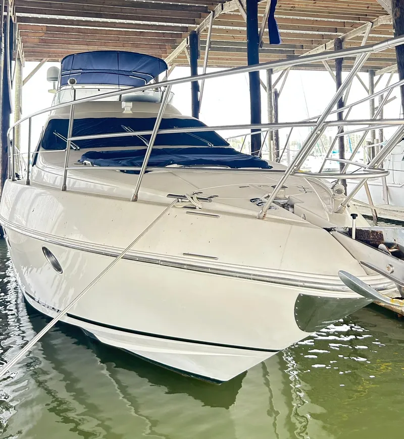 Slide: The Image of 2006 Azimut 62 yacht docked in a marina, showcasing sleek design and luxury features. - 21