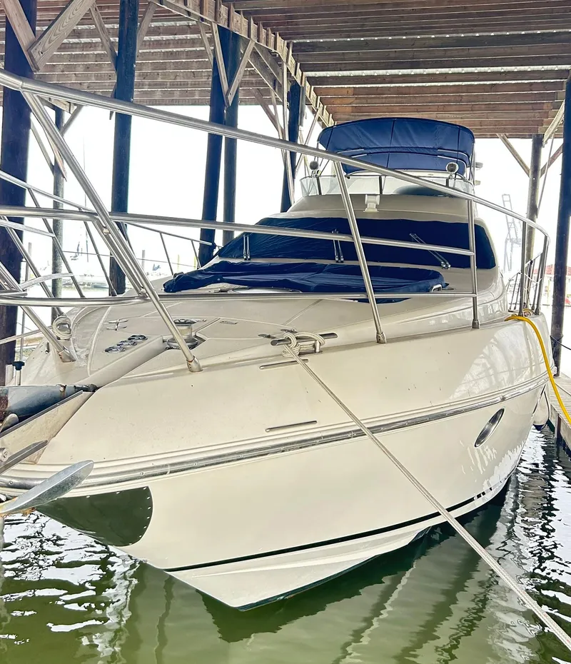 Slide: The Image of 2006 Azimut 62 yacht docked under a wooden shelter. - 22