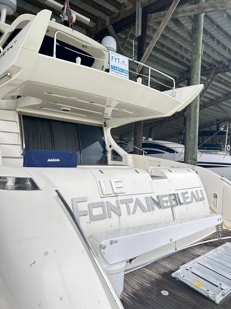 Slide: The Image of Azimut 62 yacht from 2006 docked, featuring sleek design and spacious deck area. - 30