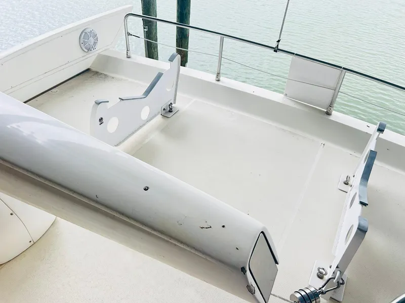 Slide: The Image of Azimut 62 yacht deck, 2006 model, featuring sleek design and railing, docked by water. - 33