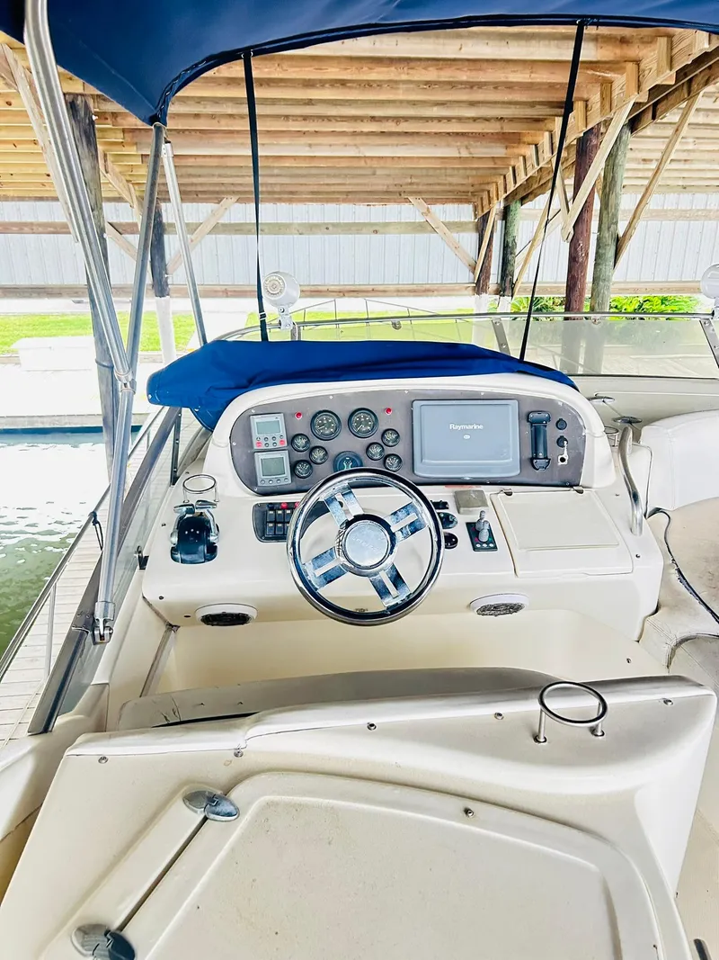 Slide: The Image of 2006 Azimut 62 yacht helm with navigation controls under a covered dock. - 37