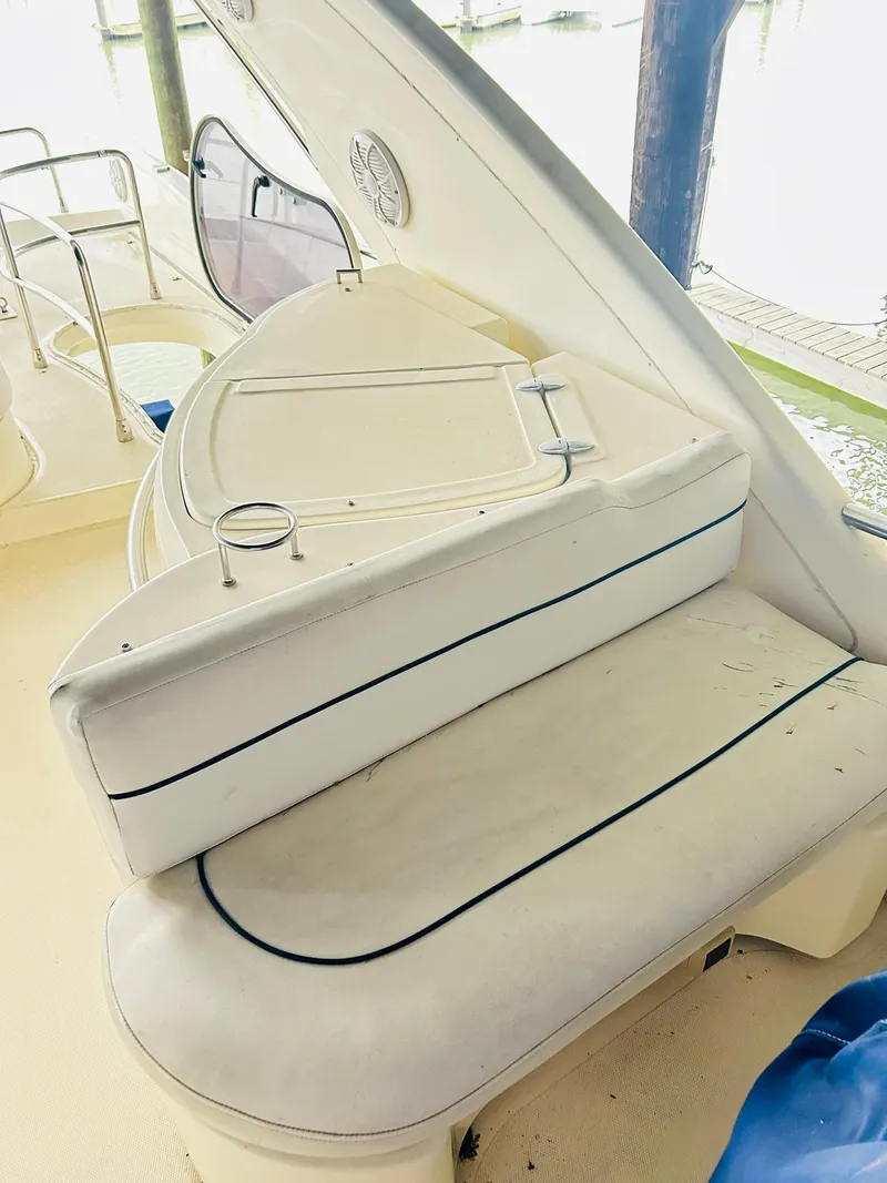 Slide: The Image of 2006 Azimut 62 yacht interior with white seating and cup holders. - 38