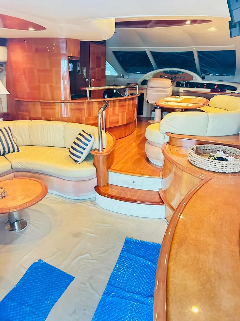Slide: The Image of Luxurious interior of a 2006 Azimut 62 yacht with elegant wood finishes and plush seating. - 47