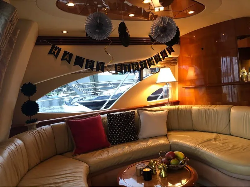 Slide: The Image of Luxurious 2006 Azimut 62 yacht interior with birthday decorations and cozy seating area. - 7