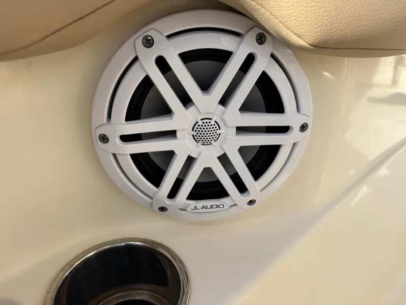 Slide: The Image of White JL Audio speaker on 2023 Scout 215 XSF boat interior. - 13
