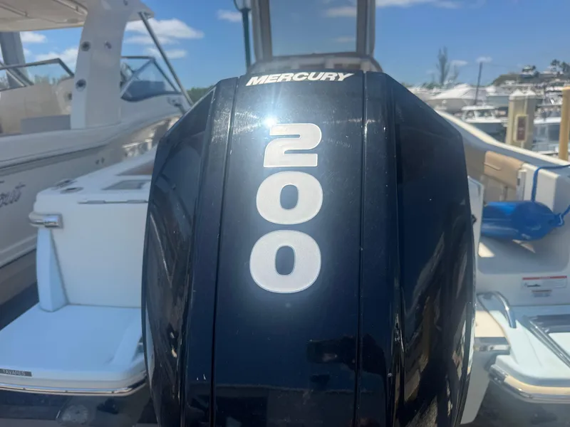 Slide: The Image of 2023 Scout 215 XSF boat with Mercury 200 engine at marina. - 4