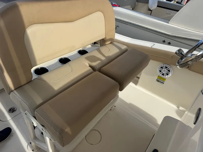 Slide: The Image of 2023 Scout 215 XSF boat interior with beige seating and cup holders. - 9