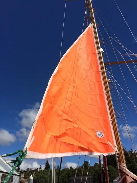 Slide: The Image of Interior of 1985 Bristol Channel Cutter 28 with plaid seating and nautical decor. - 16