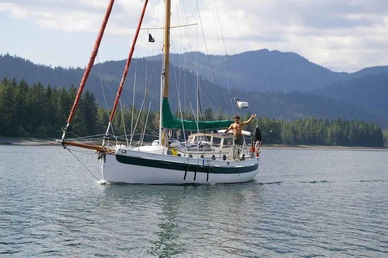 Slide: The Image of 1985 Bristol Channel Cutter 28 sailing in scenic mountain lake. - 2