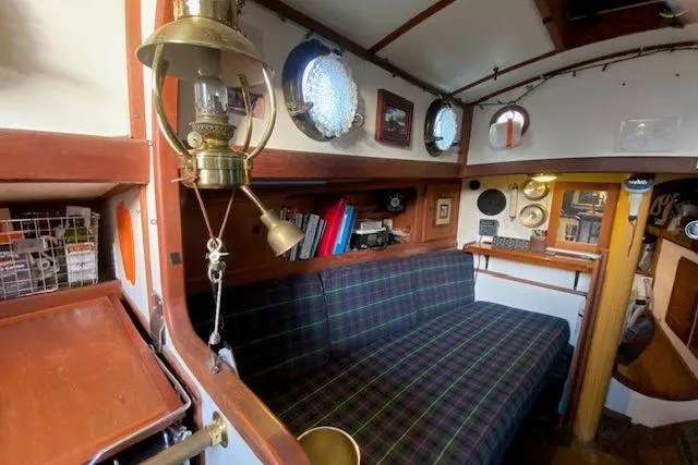 Slide: The Image of Interior of 1985 Bristol Channel Cutter 28 with plaid seating and nautical decor. - 20