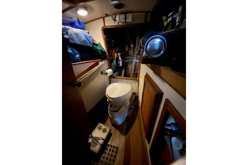 Slide: The Image of Interior of 1985 Bristol Channel Cutter 28, featuring compact marine bathroom. - 25