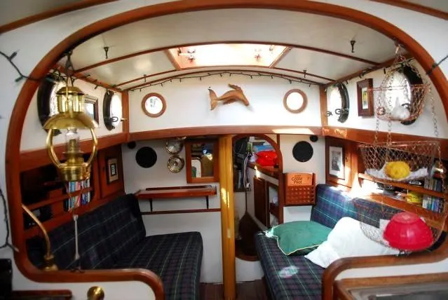 Slide: The Image of 1985 Bristol Channel Cutter 28 with solar panel and wind turbine on calm water. - 3