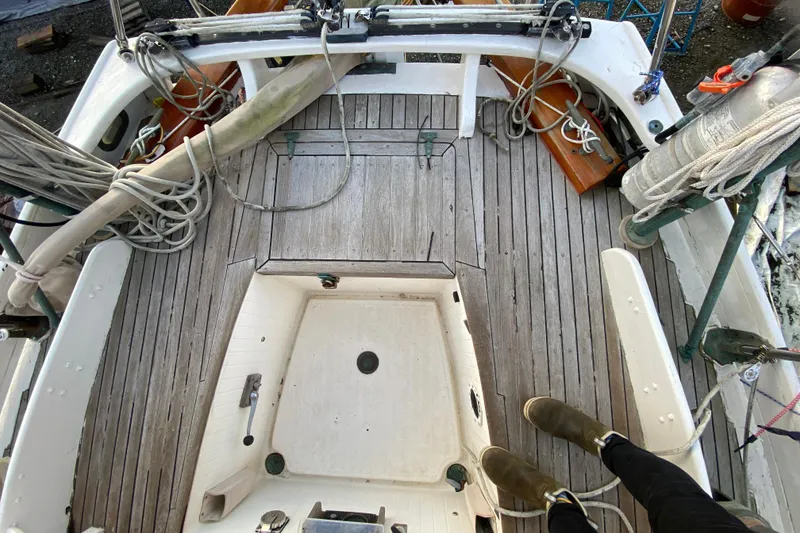 Slide: The Image of Cockpit of a 1985 Bristol Channel Cutter 28 sailboat with wooden deck and rigging. - 32