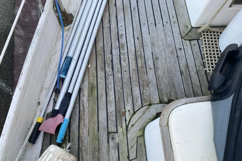 Slide: The Image of Wooden deck of a 1985 Bristol Channel Cutter 28 with cleaning tools. - 34