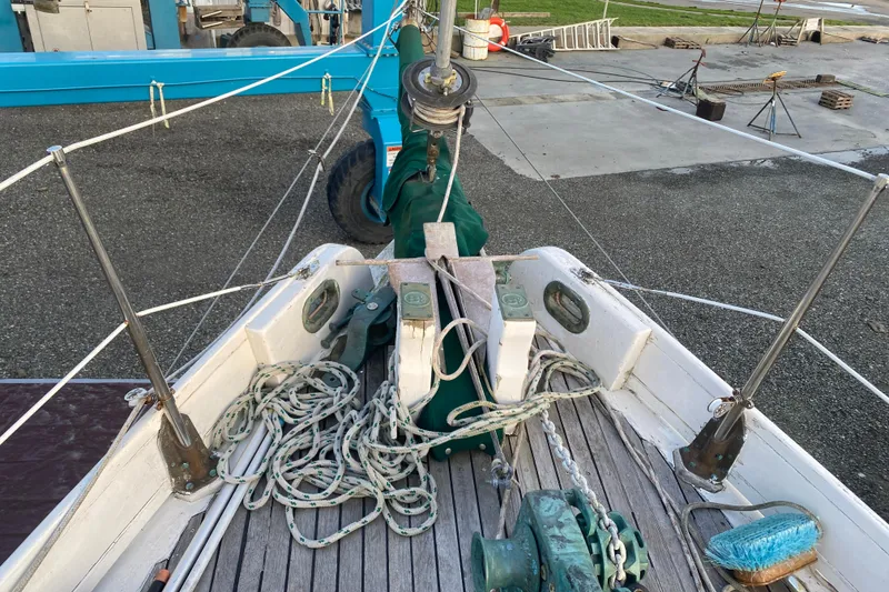 Slide: The Image of 1985 Bristol Channel Cutter 28 sailboat deck with ropes and winch, docked on land. - 35