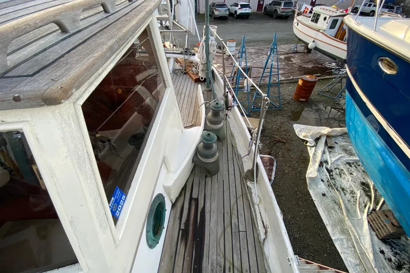 Slide: The Image of 1985 Bristol Channel Cutter 28 on deck, showcasing winches and wooden details. - 39