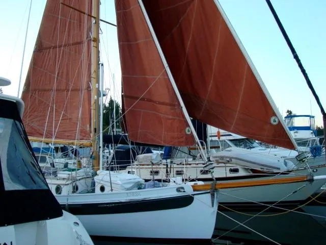 Slide: The Image of 1985 Bristol Channel Cutter 28 sailboat with red sails and deck view. - 7