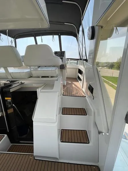 Slide: The Image of 1997 Carver 400 CPMY yacht interior with white seating and wooden steps. - 15