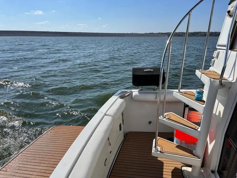 Slide: The Image of 1997 Carver 400 CPMY yacht deck with stairs, overlooking calm waters. - 17