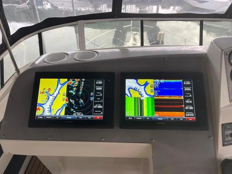 Slide: The Image of Dual navigation screens on a 1997 Carver 400 CPMY yacht dashboard. - 31