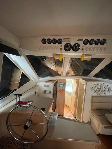 Slide: The Image of 1997 Carver 400 CPMY yacht interior with helm, gauges, and cabin view. - 35