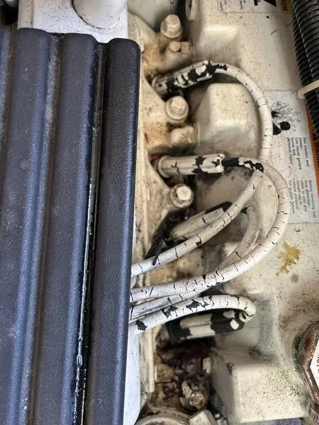 Slide: The Image of Engine components of a 1997 Carver 400 CPMY with worn cables and connectors. - 45