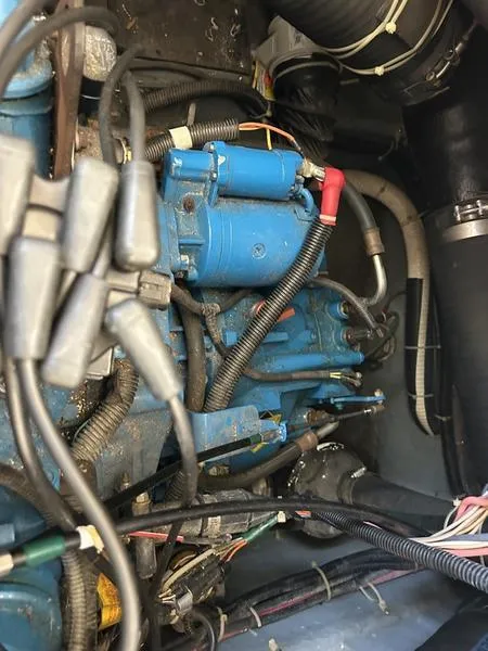 Slide: The Image of Engine compartment of a 1997 Carver 400 CPMY with visible wiring and components. - 48