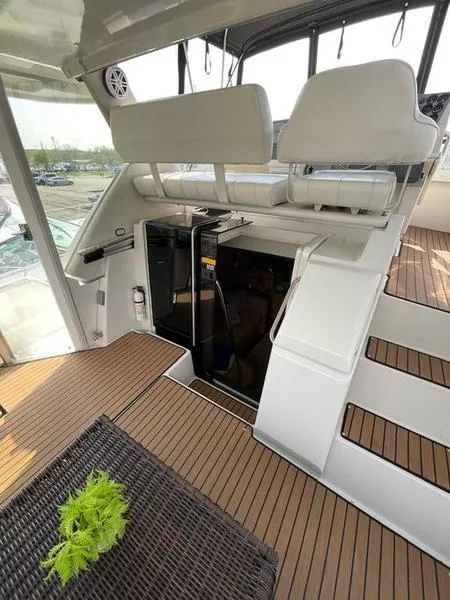 Slide: The Image of 1997 Carver 400 CPMY yacht interior with seating, stairs, and wooden flooring. - 6