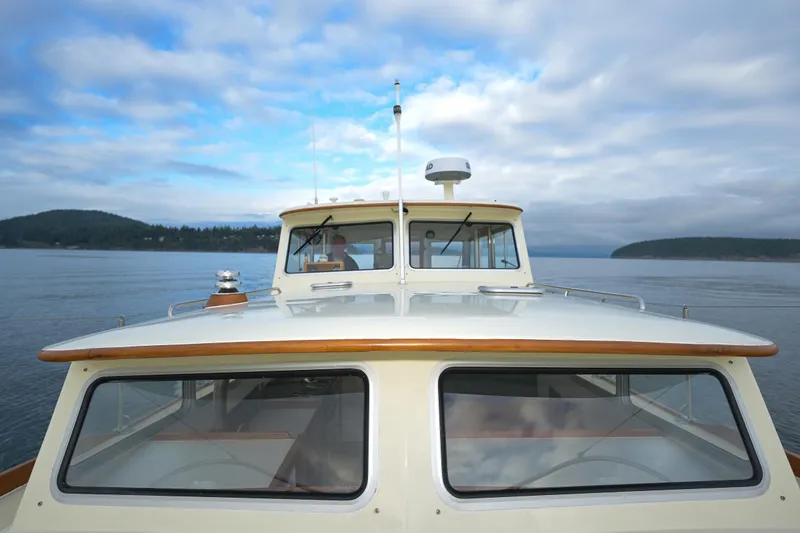 Slide: The Image of 1975 Rough Water 35 boat on calm waters under a cloudy sky. - 10