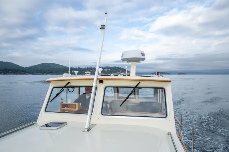 Slide: The Image of 1975 Rough Water 35 boat cruising on a calm lake under a cloudy sky. - 11