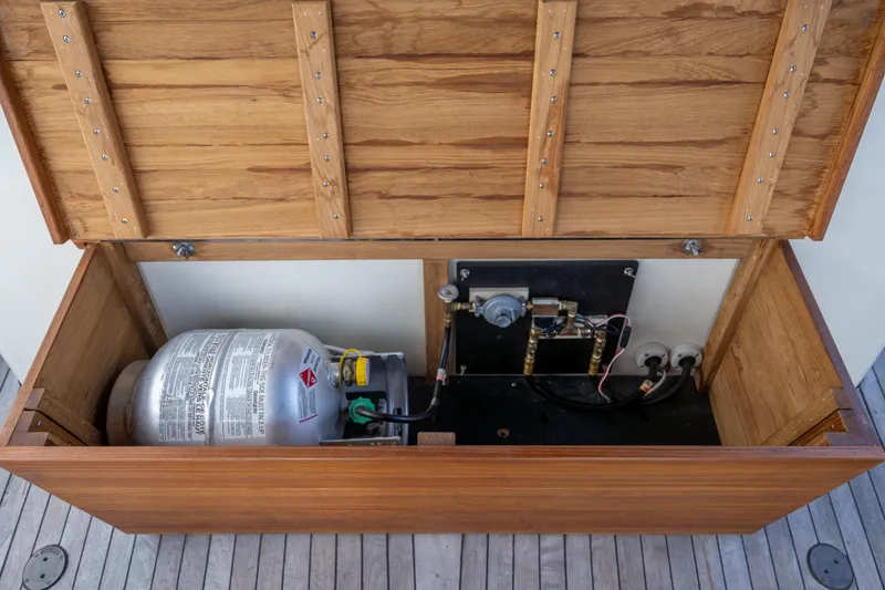 Slide: The Image of Open wooden storage compartment with gas cylinder and equipment, Rough Water 35, 1975 model. - 16