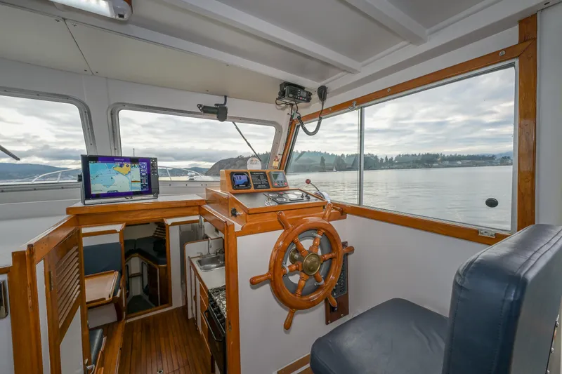 Slide: The Image of Interior of 1975 Rough Water 35 boat with wooden steering wheel and navigation equipment. - 17
