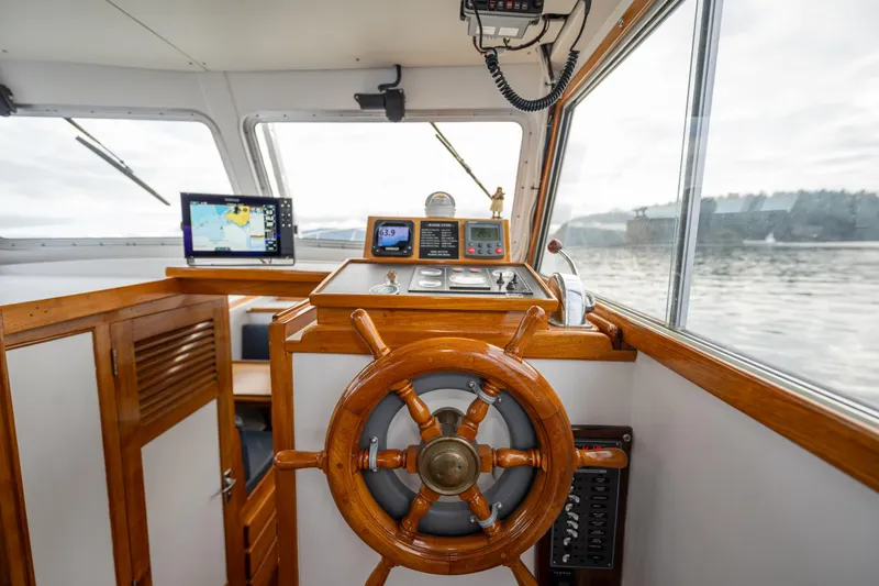 Slide: The Image of Helm of 1975 Rough Water 35 boat with wooden wheel and navigation equipment. - 18