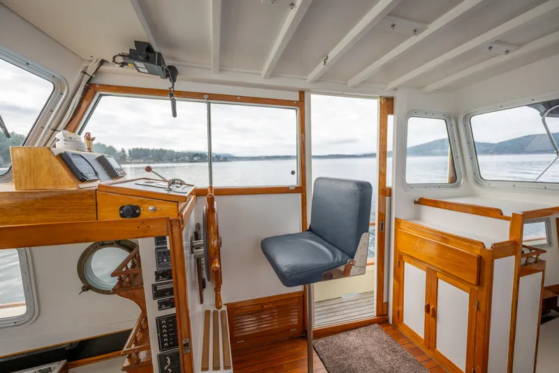 Slide: The Image of Interior of 1975 Rough Water 35 boat with wooden accents and scenic lake view. - 20