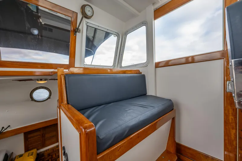 Slide: The Image of Interior of a 1975 Rough Water 35 boat with wooden trim and cushioned seating. - 21