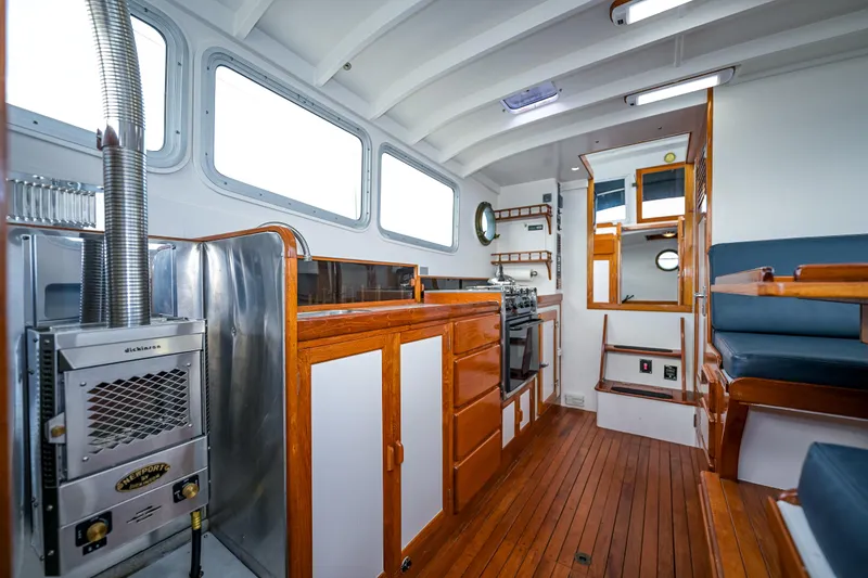Slide: The Image of Interior of a 1975 Rough Water 35 boat with wooden flooring and modern amenities. - 23