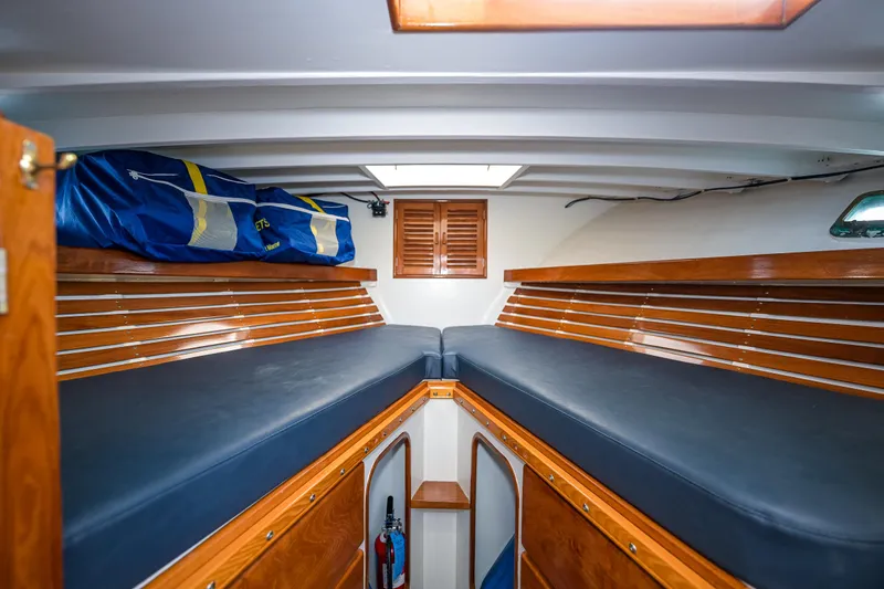 Slide: The Image of Interior of 1975 Rough Water 35 boat with wooden bunks and storage. - 25