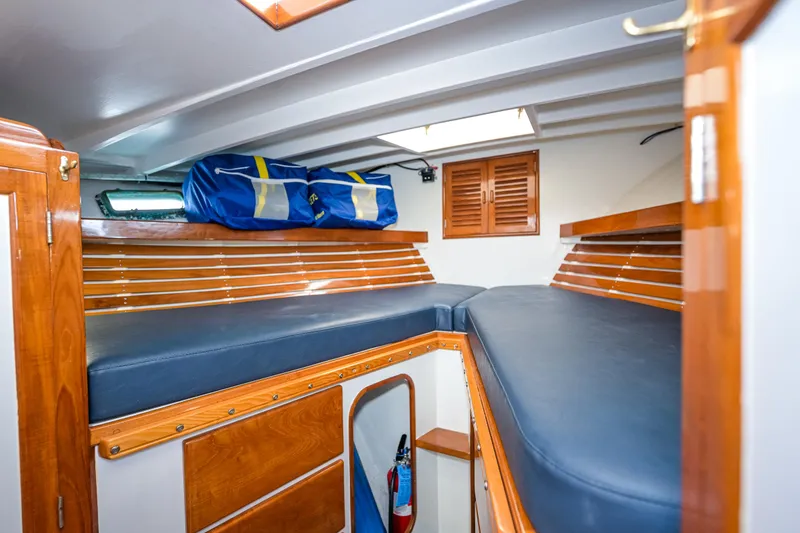 Slide: The Image of Interior of 1975 Rough Water 35 boat with blue cushions and wooden accents. - 26