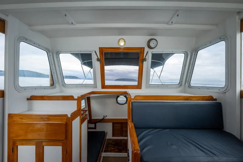 Slide: The Image of Interior of a 1975 Rough Water 35 boat with wooden accents and panoramic windows. - 28