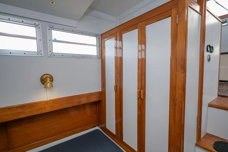 Slide: The Image of Interior of 1975 Rough Water 35 boat with wooden cabinets and wall lamp. - 32