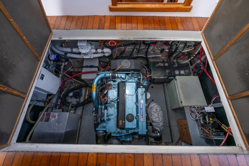 Slide: The Image of Engine room of a 1975 Rough Water 35 boat, showcasing mechanical components and wiring. - 33