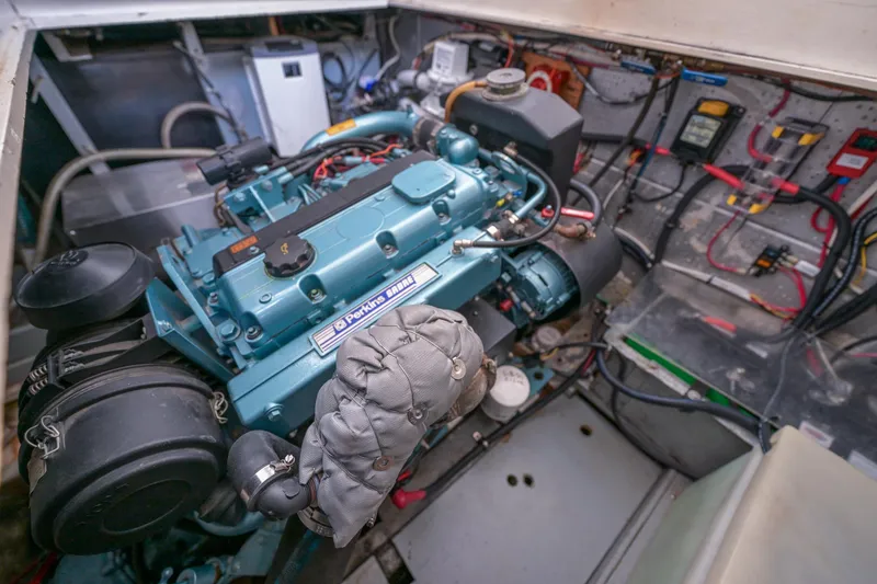 Slide: The Image of Engine room of a 1975 Rough Water 35 boat, featuring a detailed marine engine. - 34