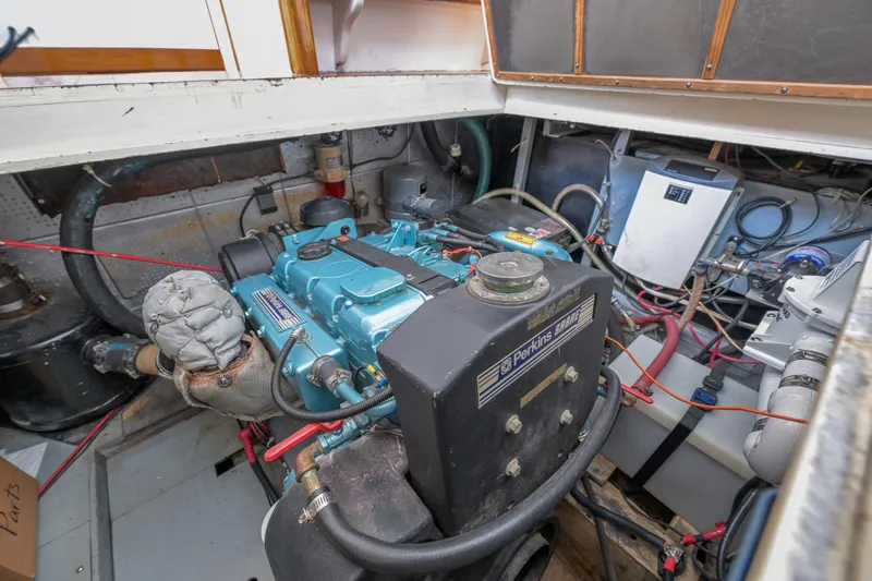 Slide: The Image of Engine room of a 1975 Rough Water 35 boat, featuring a Perkins engine. - 36