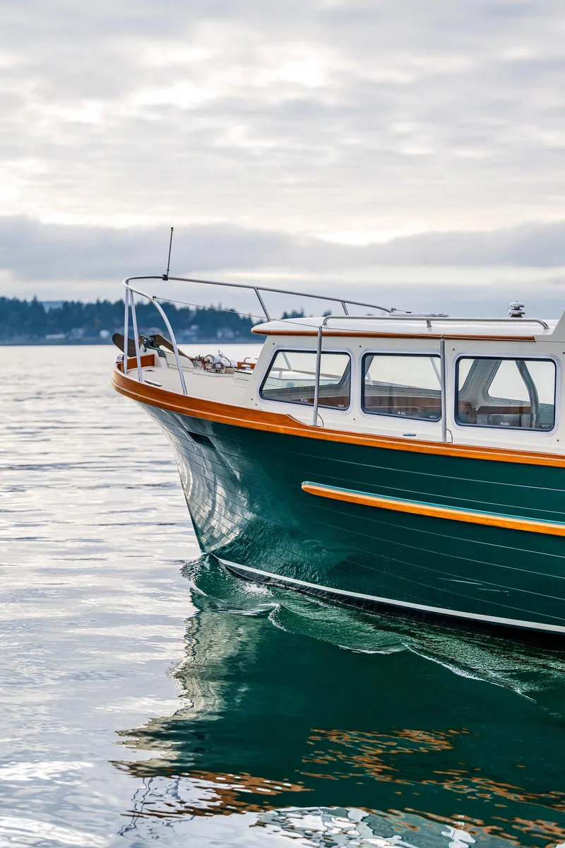 Slide: The Image of Classic 1975 Rough Water 35 boat cruising on calm waters under a cloudy sky. - 4