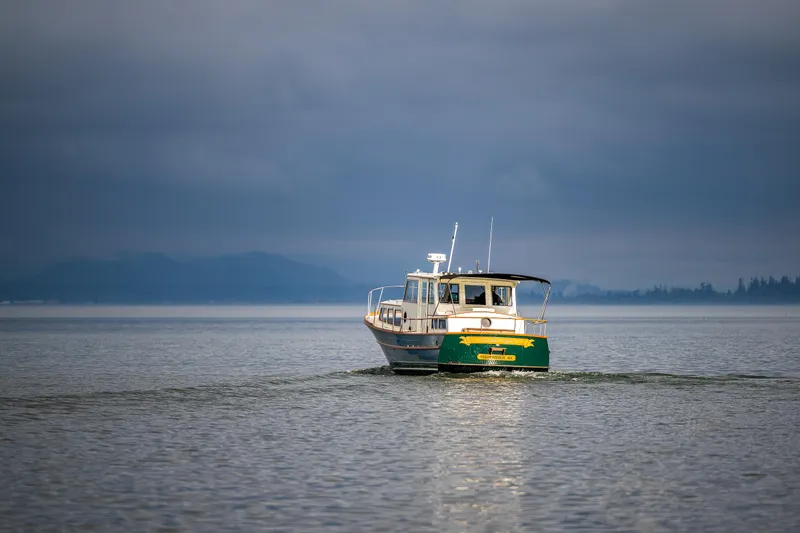 Slide: The Image of Vintage 1975 Rough Water 35 boat cruising on a calm, overcast lake. - 6