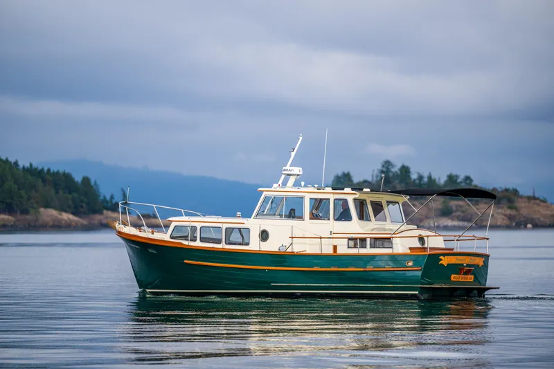 Slide: The Image of Classic 1975 Rough Water 35 boat on calm waters, scenic background. - 7