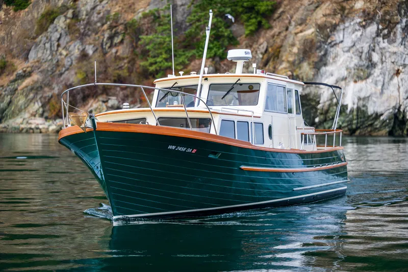 Slide: The Image of Classic 1975 Rough Water 35 boat cruising near rocky shoreline. - 8