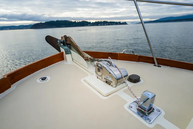 Slide: The Image of Bow of 1975 Rough Water 35 boat with anchor winch, scenic water view. - 9