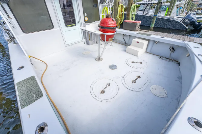 Slide: The Image of Spacious deck of 1983 Resmondo 38 boat with storage hatches and equipment. - 10